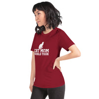 Cat mom world tour graphic featuring a cat, printed on a cardinal t-shirt, front view