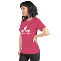 Cat mom world tour graphic featuring a cat, printed on a heather raspberry t-shirt, front view