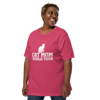 Cat mom world tour graphic featuring a cat, printed on a heather raspberry t-shirt, front view