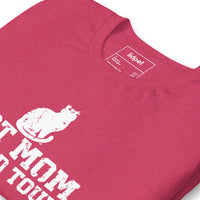 Cat mom world tour graphic featuring a cat, printed on a heather raspberry t-shirt, front view