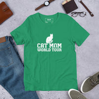 Cat mom world tour graphic featuring a cat, printed on a light t-shirt, front view