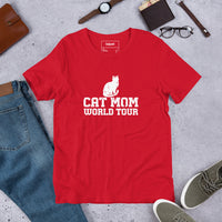 Cat mom world tour graphic featuring a cat, printed on a red t-shirt, front view