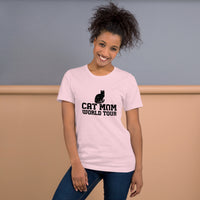Cat mom world tour graphic featuring a cat, printed on a pink t-shirt, front view