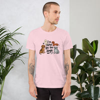 I'm here for the dogs graphic featuring dogs, printed on a pink t-shirt, front view