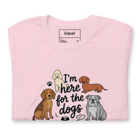 I'm here for the dogs graphic featuring dogs, printed on a pink t-shirt, front view