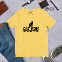 Cat mom world tour graphic featuring a cat, printed on a light t-shirt, front view